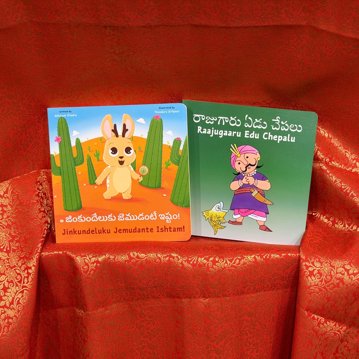 Two children's books on a red fabric background